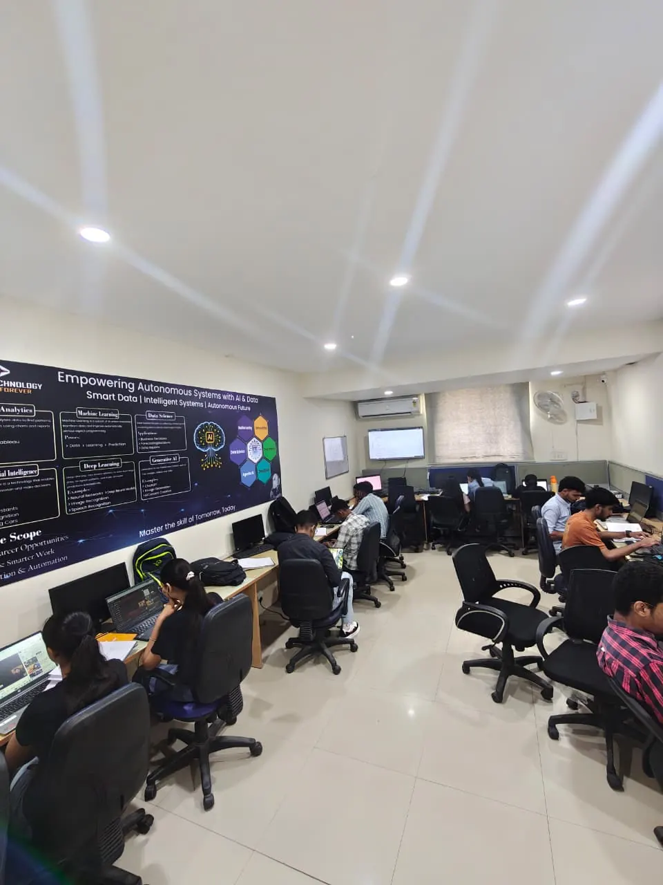 Full classroom of students learning technology skills at Ziion Technology